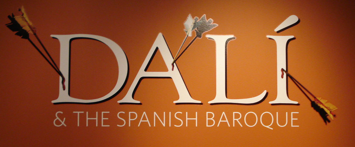 Text reads "Dali and the Spanish Baroque" with arrows sticking out of the word "Dali"