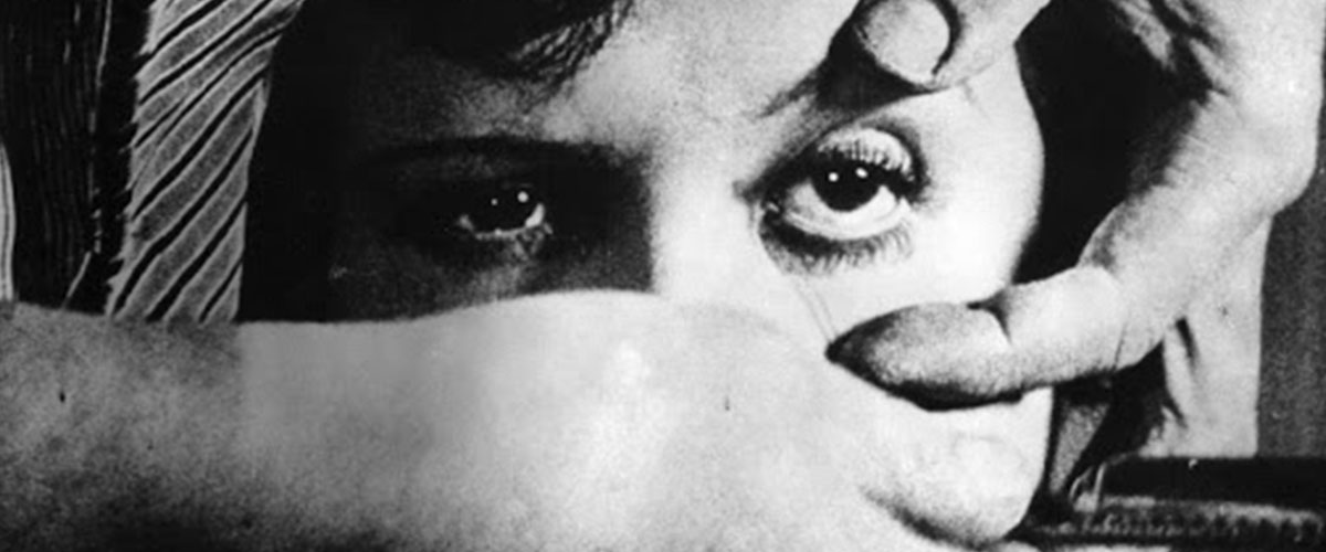 Still from Salvador Dali and Luis Buñuel's film "Un Chien Andalou," man holds womans eye open to slice it with a razor blade