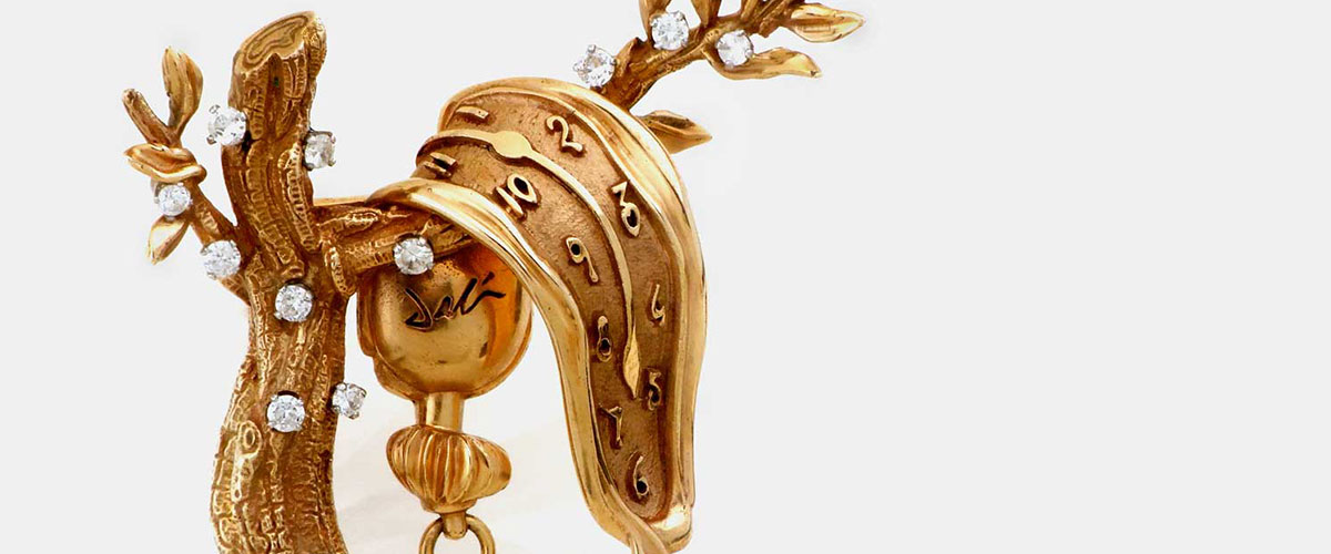Salvador Dali gold jewelry, melting clock over a leafy branch covered in gems