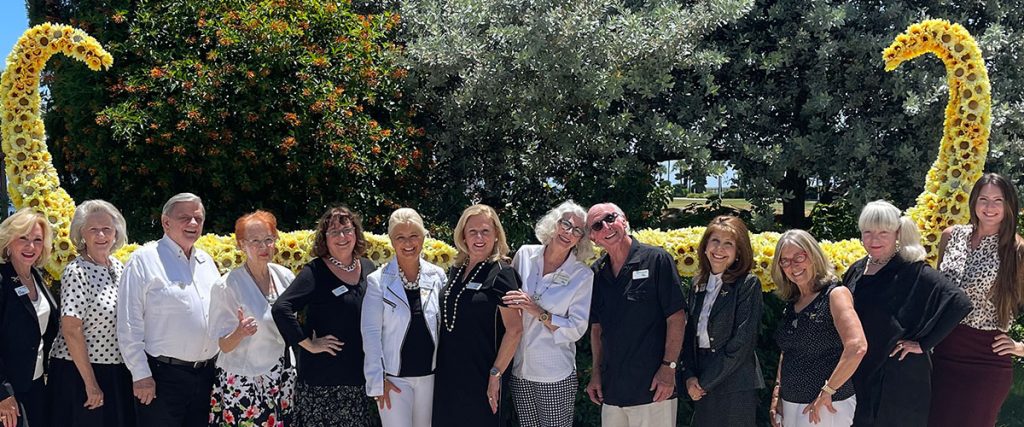 The Guild at The Dali Museum posing in front of the mustache sculpture