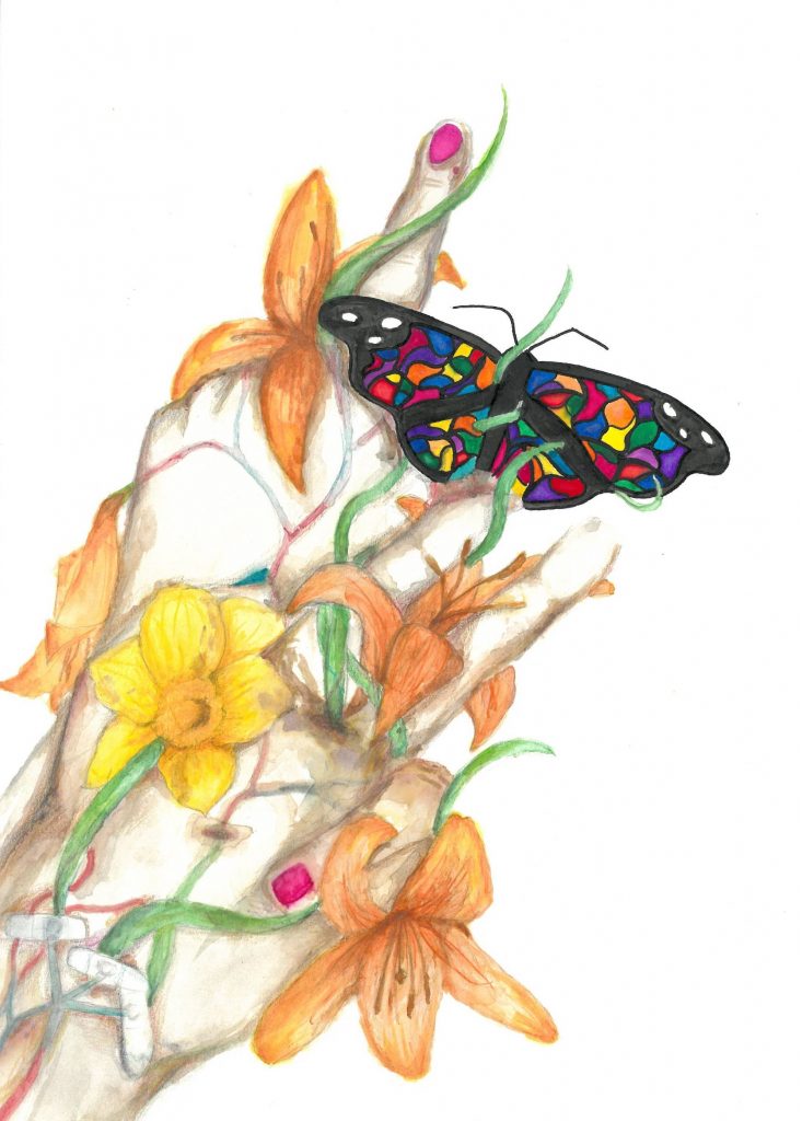 A butterfly is perched on a hand that is covered in flowers