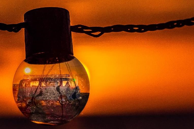 A light bulb with a sunset in the background