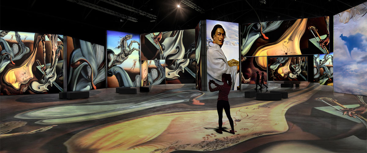 Visitor surrounded by immersive Dalí paintings