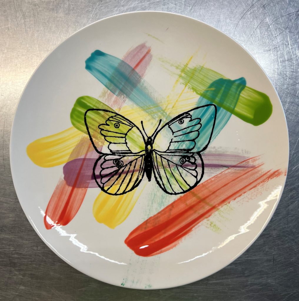 Plate with a butterfly and paint