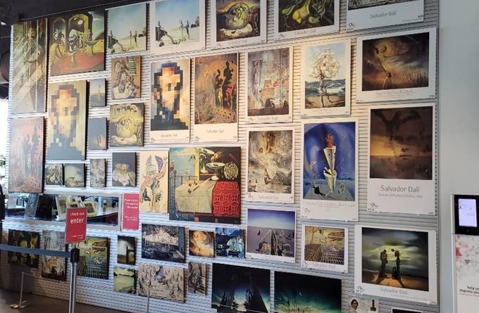 Wall of Dalí reproduction posters and matted prints. 