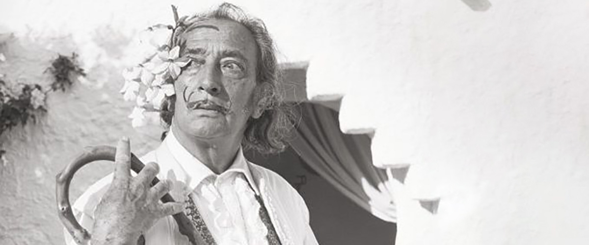 Black and white Dali with flowers next to his head