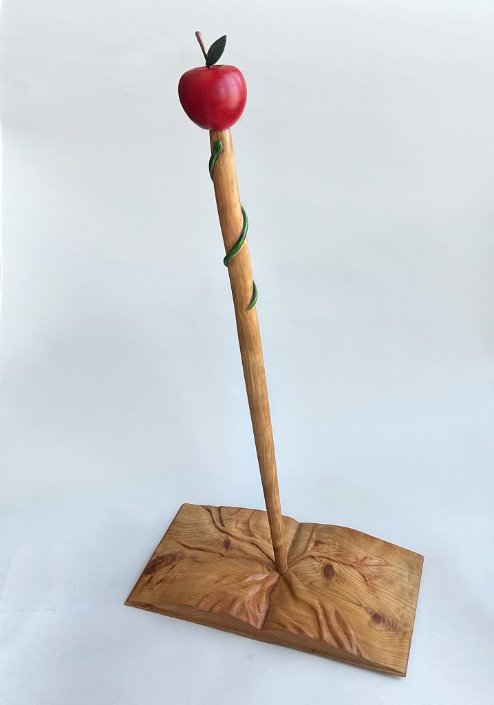 a wooden stick with a red ball on top
