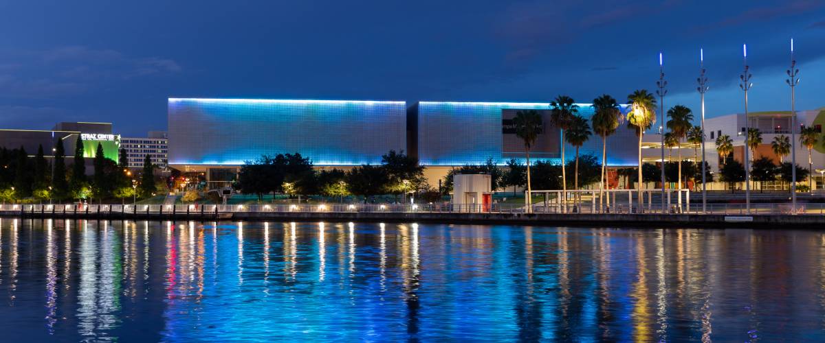 Building lit up in blue on the water