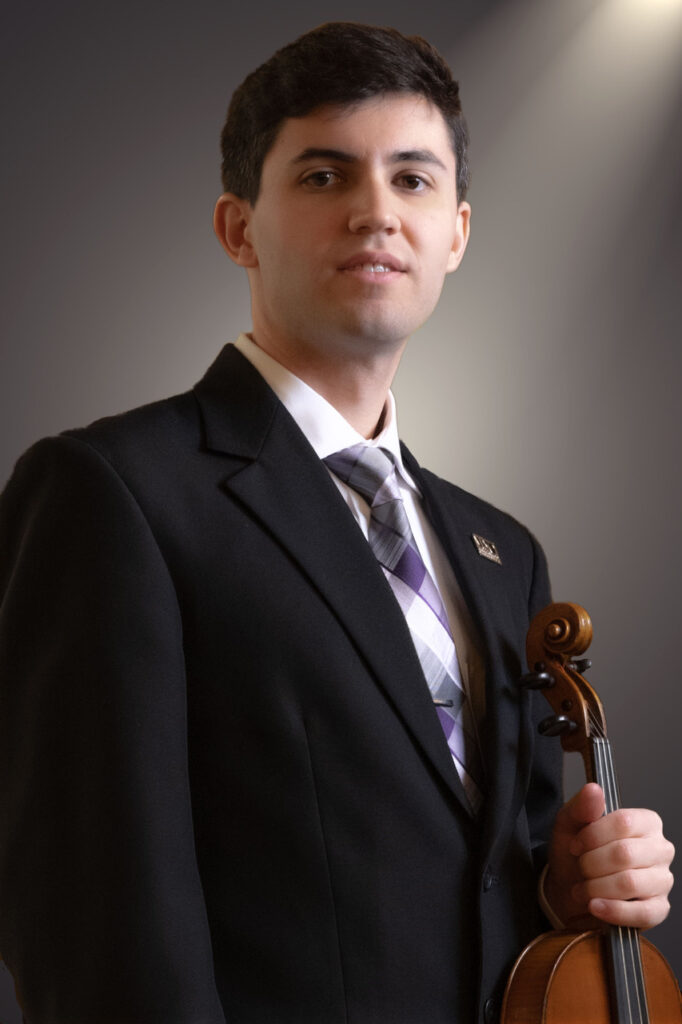 photo of a person standing in a suit with a violin